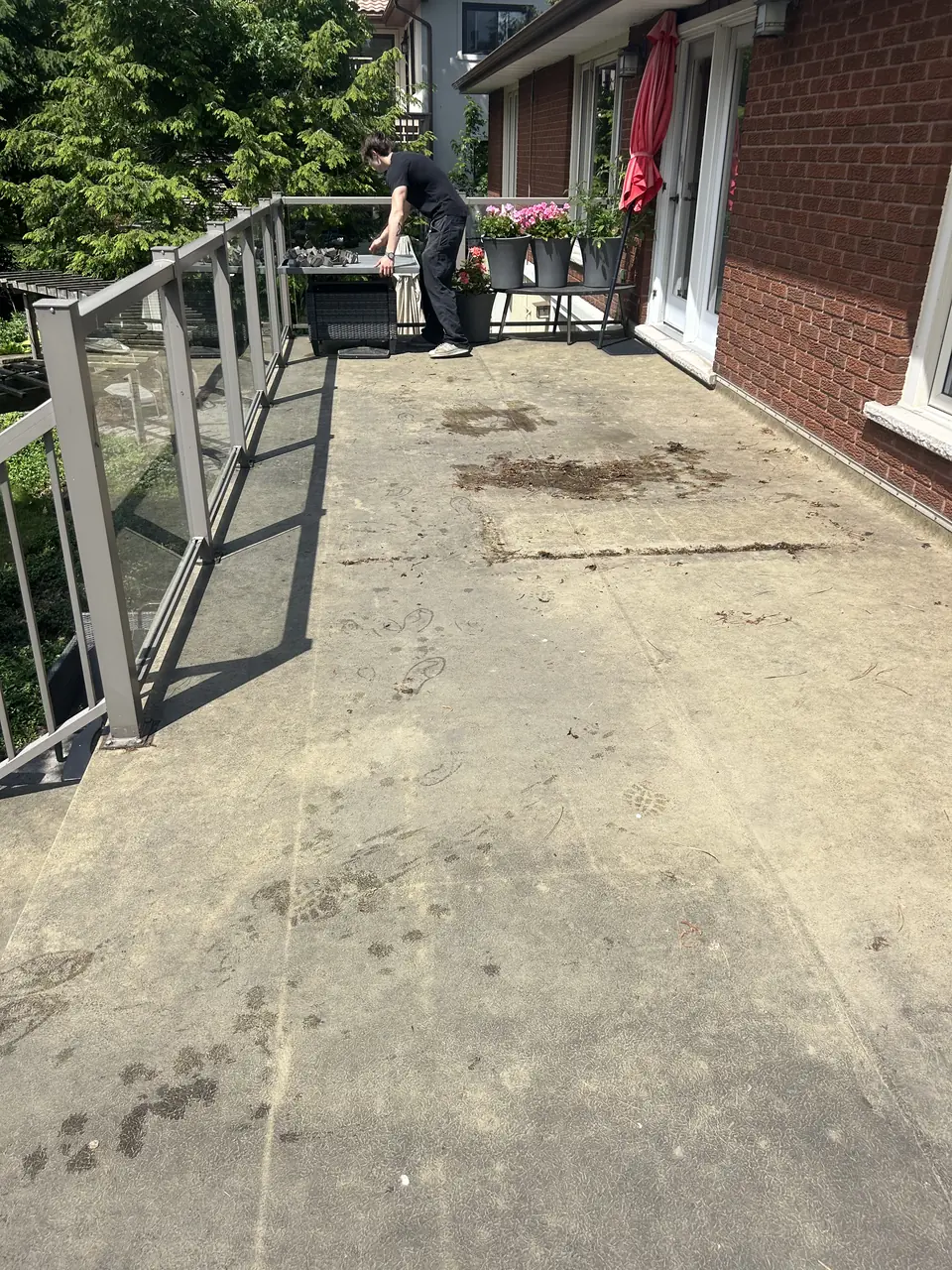 Concrete balcony before pressure washing in Kingston — grime and moss