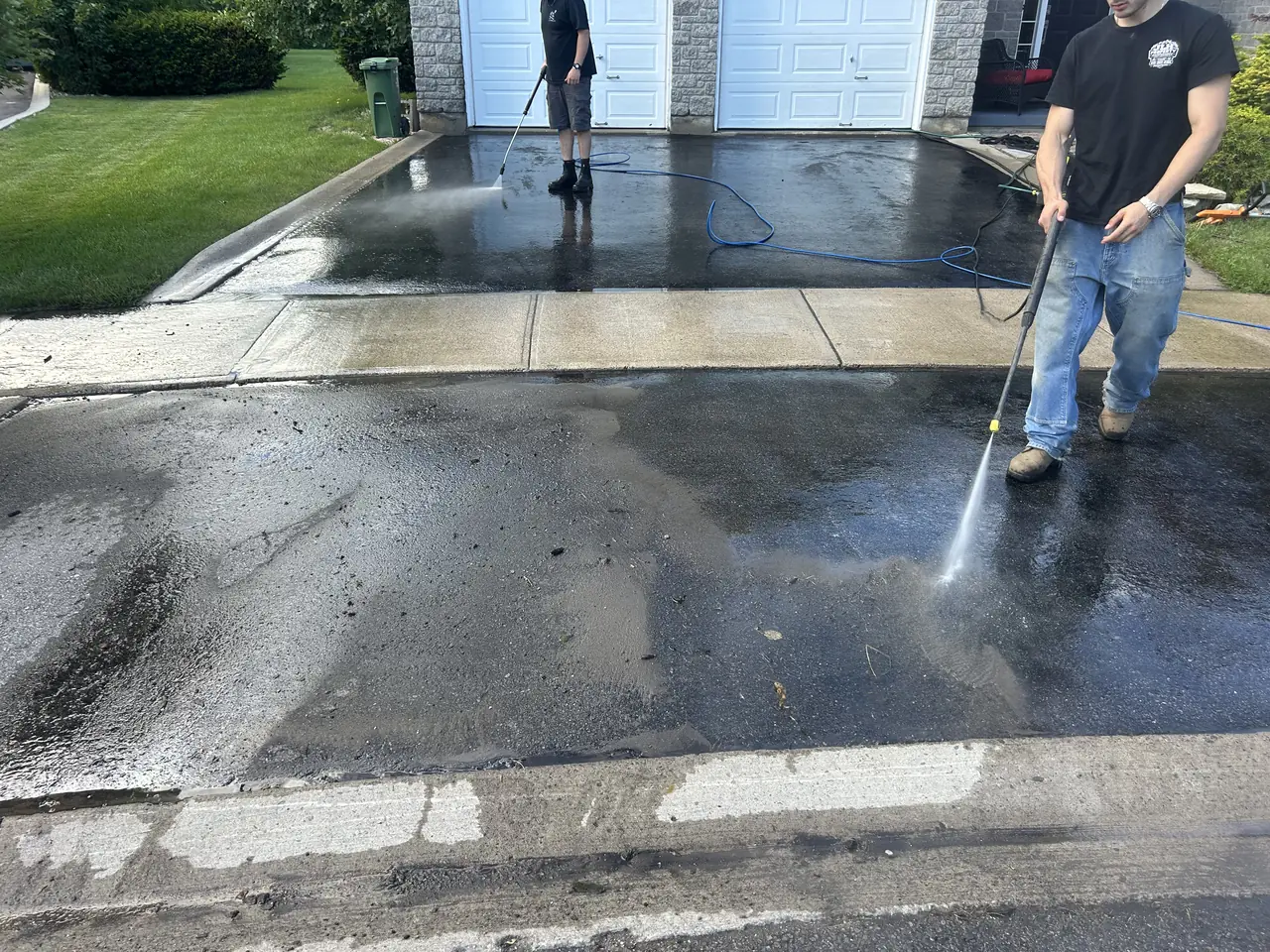 Asphalt driveway being pressure washed before sealing in Kingston