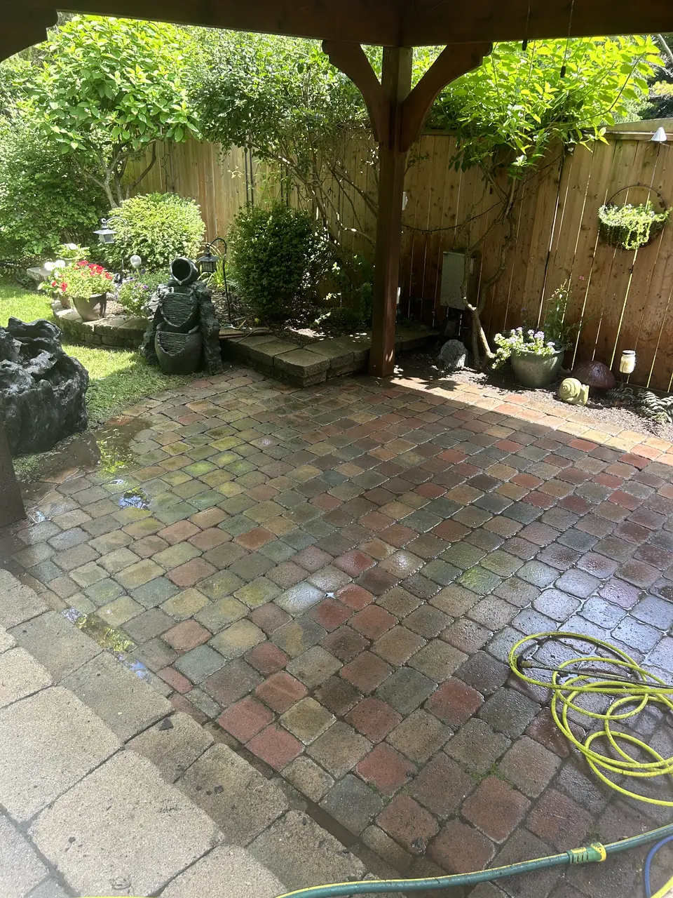 Stone patio corner freshly pressure washed in Kingston