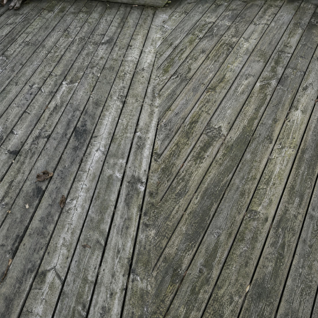 Wood deck before cleaning — grey weathered and dirty